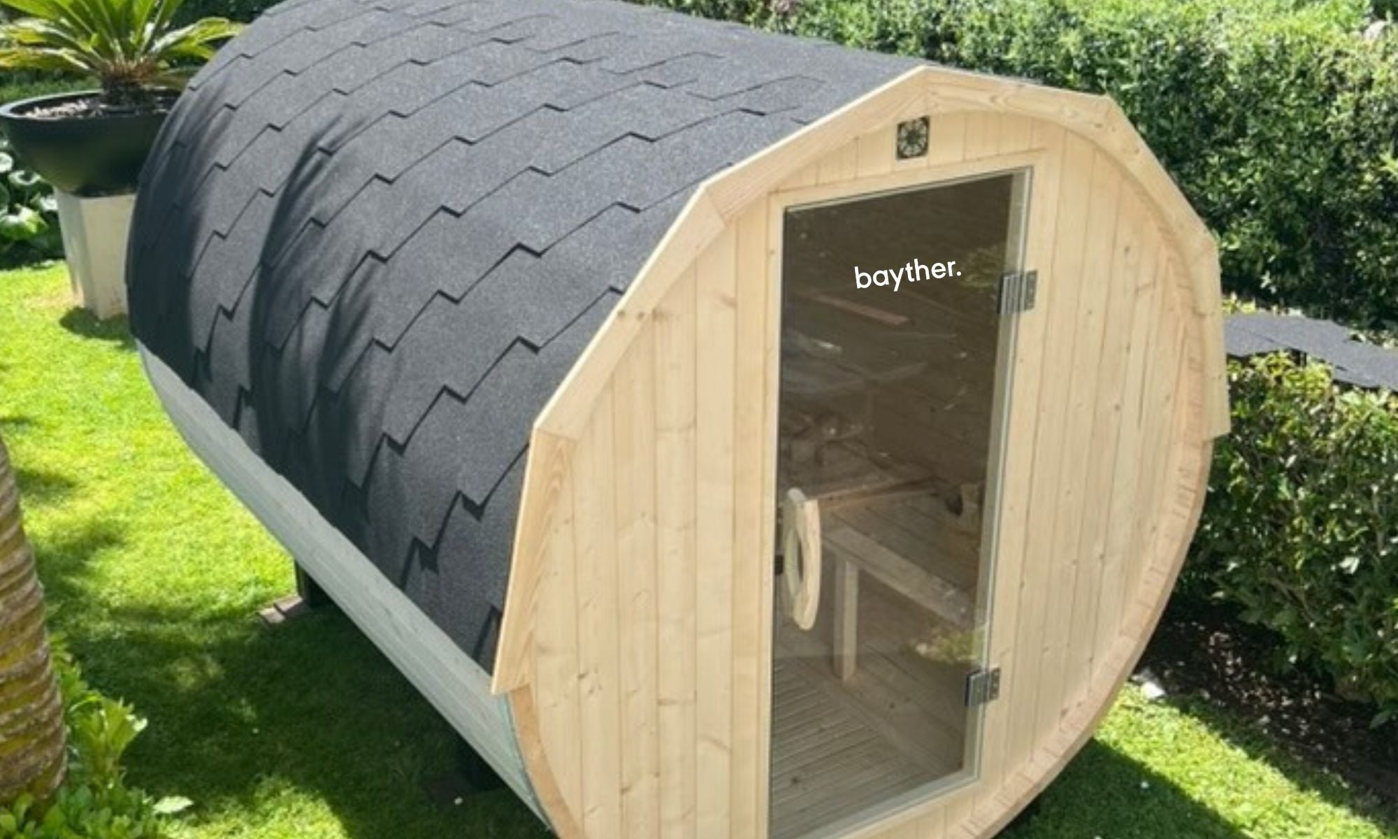 Bayther outdoor barrel sauna installed in a backyard garden in New Zealand