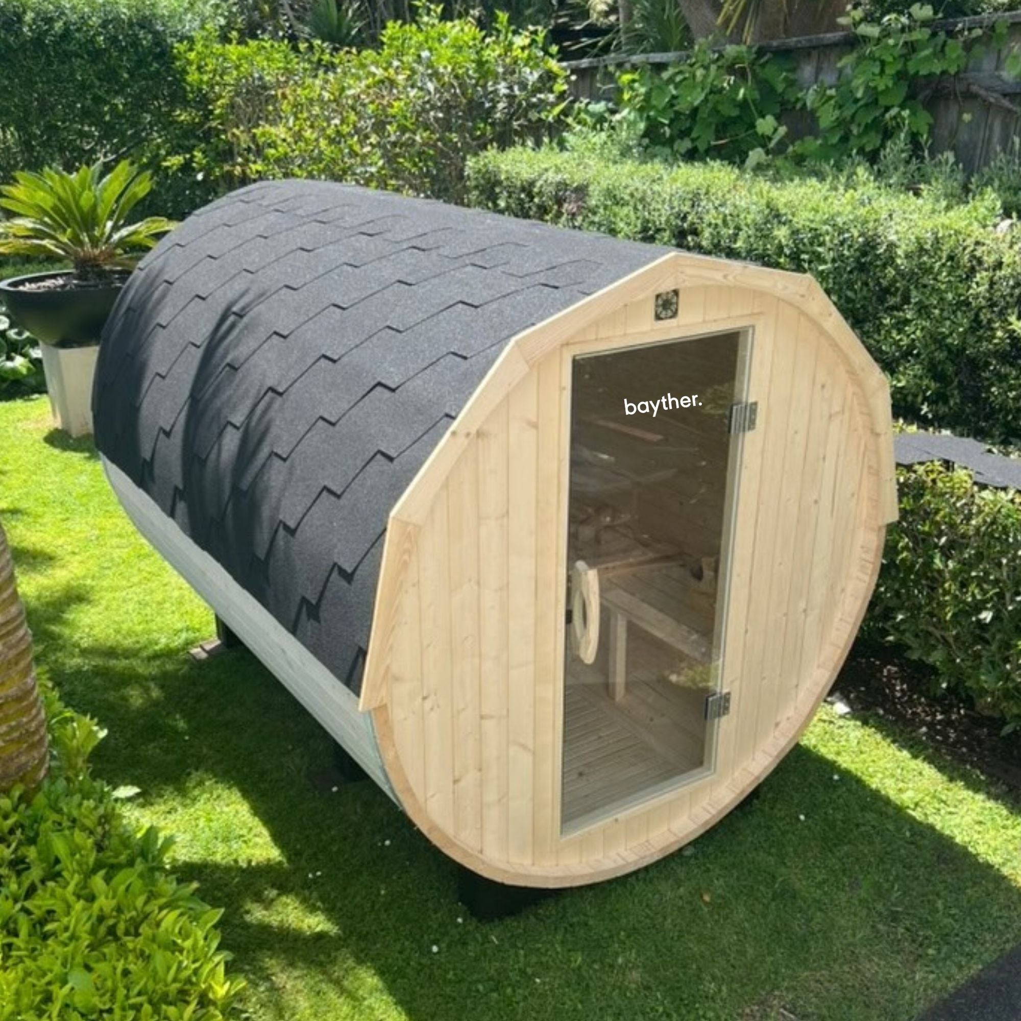Bayther outdoor barrel sauna installed in a backyard garden in New Zealand