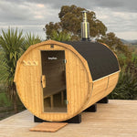Bayther outdoor barrel sauna installed on a deck with wood fired chimney
