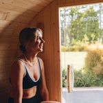 Inside a wood fired barrel sauna with timber interior and bench seating
