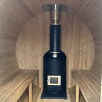 Traditional wood fired sauna heater inside a barrel sauna